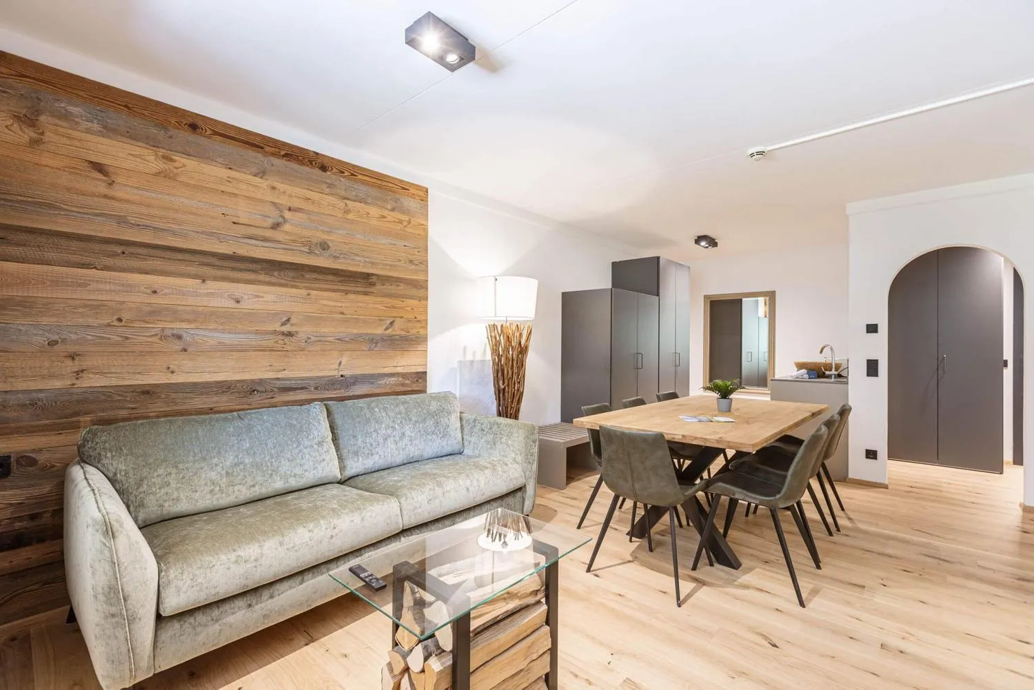 Wohnzimmer mit großer Holztrennwand und Essplatz