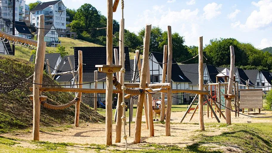 Großer Holz-Spielplatz mit Kletterelementen und Netzen für Kinder