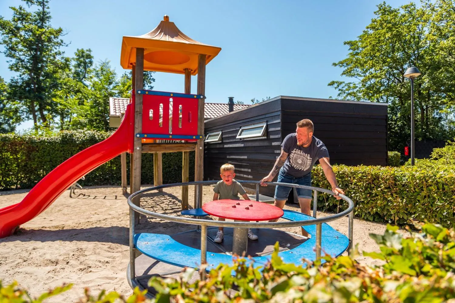 EuroParcs Empfangsgebäude mit Flaggen und Wohnwagen-Parkplatz