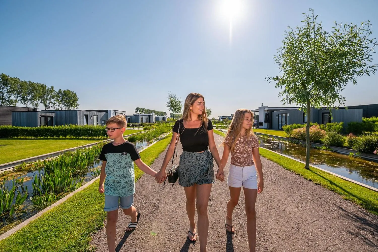 Mutter mit zwei Kindern auf Weg zwischen Häusern